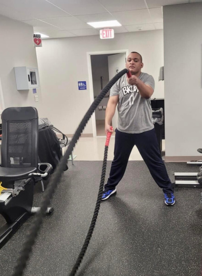 Client using an exercise rope.